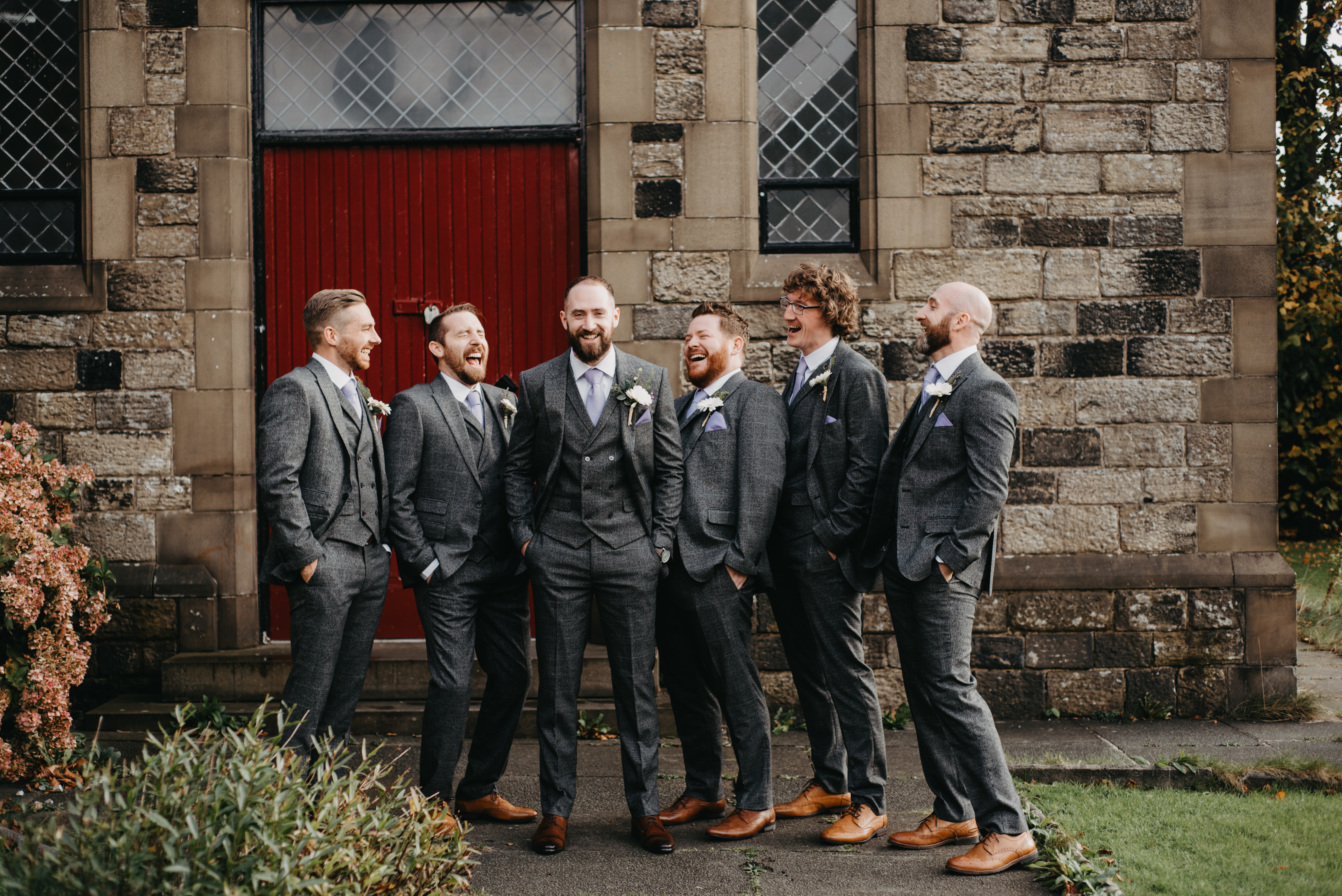A groom and his groomsmen laughing